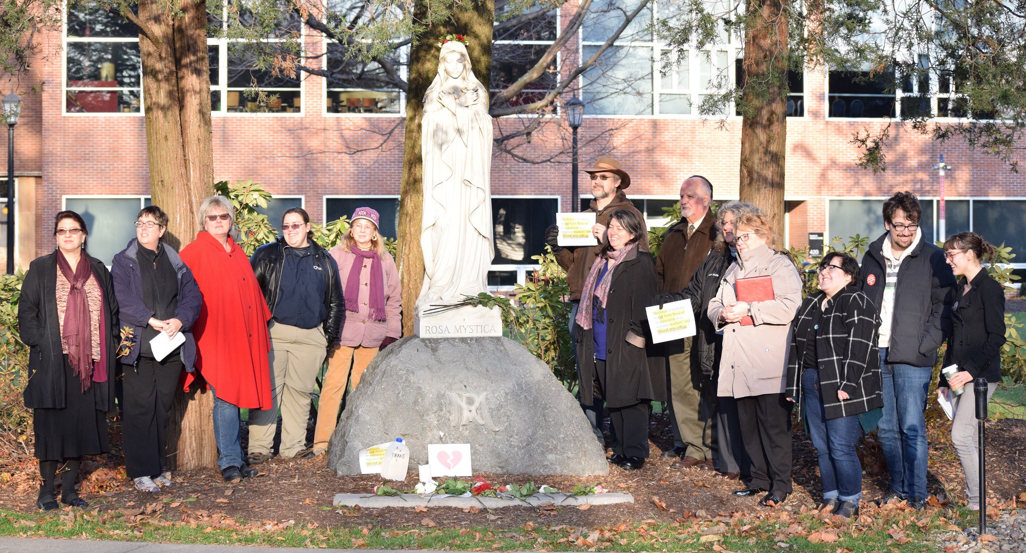 A large number of the Saint Rose community came out to say a few words and drop a rose in front of the campus statue